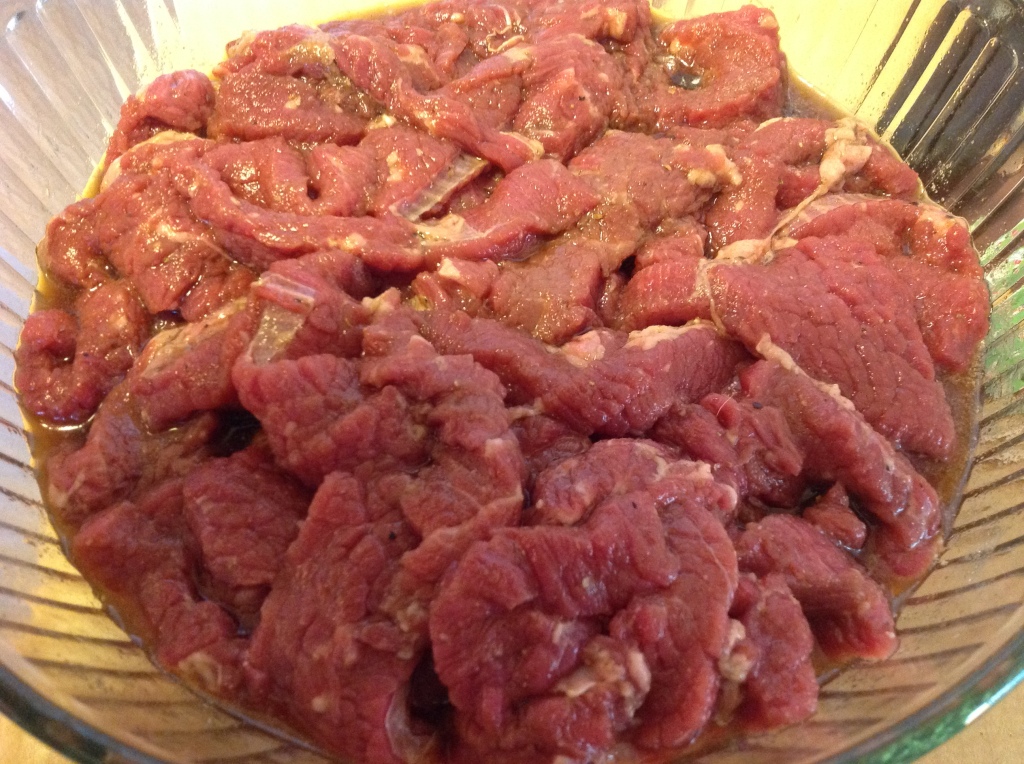 Meat sliced up and marinade added